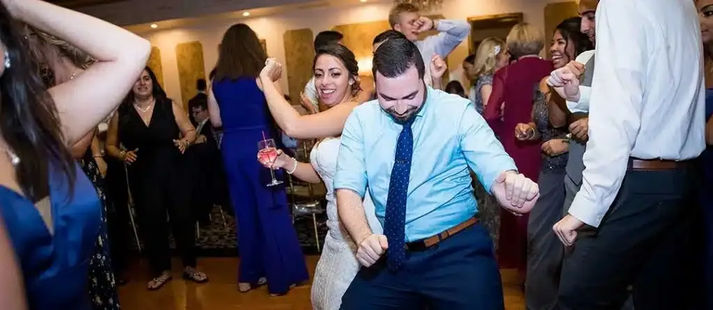 Christina & Joshua wedding with Christina dancing with a guest. Photo by Cassondre Mae Photography.